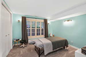 Bedroom featuring baseboards, carpet, and visible vents