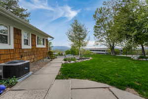 View of yard featuring a mountain view, fence, and cooling unit
