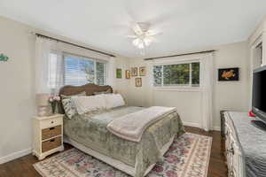 Bedroom with baseboards, a ceiling fan, and dark wood-style floors
