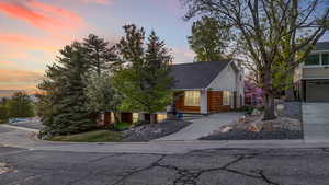 View of front of house featuring a shingled roof