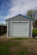 Detached garage featuring fence