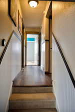 Staircase featuring wood finished floors