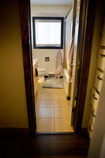 Full bath with toilet, baseboards, tile patterned flooring, and vanity