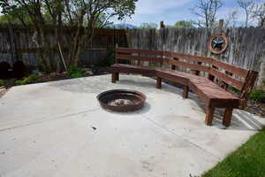 View of patio / terrace with fence and a fire pit