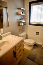 Full bathroom featuring visible vents, tile patterned flooring, curtained shower, vanity, and toilet