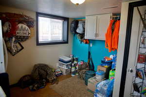 Clothes washing area featuring visible vents and a textured ceiling