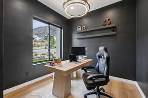 Office with baseboards and wood finished floors