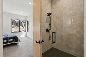 Full bathroom featuring baseboards, a stall shower, and recessed lighting