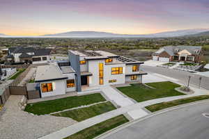 View of front of home with fence private yard, stucco siding, a mountain view, a yard, and a residential view