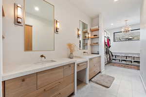 Full bathroom featuring recessed lighting, a notable chandelier, and vanity