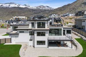 Back of house featuring a residential view, a fenced backyard, a patio area, and stucco siding