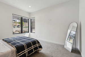 Bedroom featuring baseboards, carpet flooring, and recessed lighting