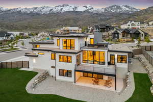 Rear view of property with a patio area, a fenced backyard, a mountain view, a balcony, and stucco siding