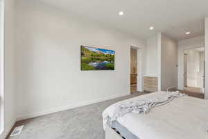 Bedroom with baseboards, light colored carpet, recessed lighting, and visible vents
