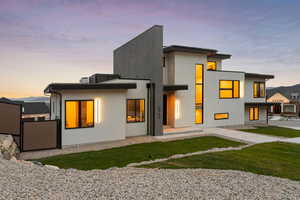 View of back of property at dusk