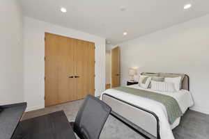 Carpeted bedroom with recessed lighting, baseboards, and a closet