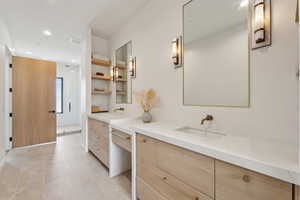 Bathroom with recessed lighting, a sink, two vanities, and visible vents