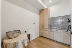 Kitchen featuring recessed lighting, light wood finished floors, baseboards, and light brown cabinets