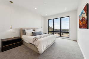 Carpeted bedroom featuring recessed lighting and baseboards