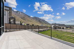 View of patio / terrace featuring fence and a mountain view