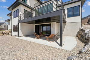 Back of house with a patio, stucco siding, and a balcony