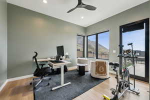 Interior space with baseboards, ceiling fan, recessed lighting, and wood finished floors