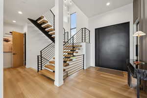 Entryway featuring stairs, recessed lighting, baseboards, and light wood finished floors