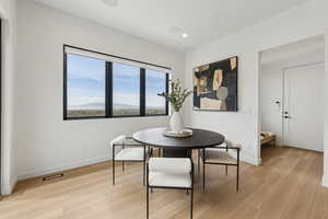 Dining room with baseboards, recessed lighting, and light wood-style flooring