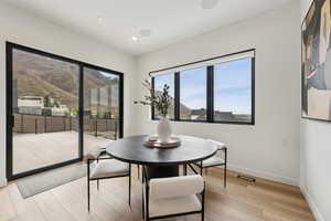 Dining space featuring light wood-style floors, baseboards, recessed lighting, and visible vents
