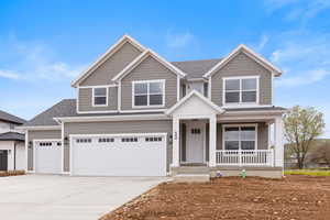 Craftsman-style house featuring covered porch, concrete driveway, roof with shingles, and 4 car garage