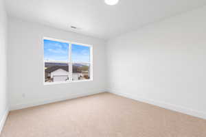 Carpeted bedroom with mountain views