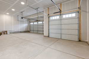 Large open 4-car garage with front and back garage doors