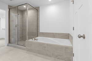 Bathroom with double vanity, water closet, and separate tub/shower.