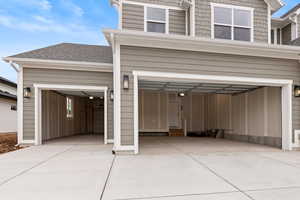 Large open 4-car garage with front and back garage doors