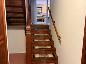 Stairway featuring baseboards