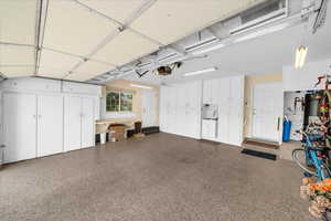 Garage featuring a garage door opener and water heater