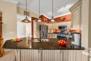 Kitchen featuring visible vents, appliances with stainless steel finishes, a sink, track lighting, and a peninsula