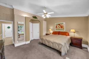Bedroom featuring crown molding, carpet, ceiling fan, and baseboards