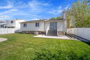 Rear view of property featuring a patio, a chimney, central AC unit, french doors, and a fenced backyard