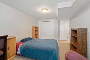 Bedroom featuring a closet and light carpet