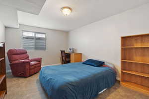 Bedroom featuring carpet and a textured ceiling
