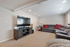 Living area featuring recessed lighting, baseboards, and light colored carpet