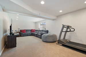 Carpeted living room featuring baseboards and recessed lighting