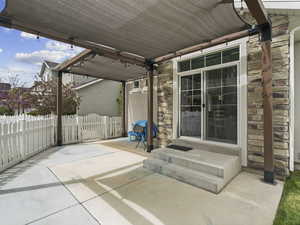 View of patio / terrace featuring fence and entry steps