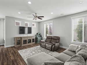 Living area with baseboards, recessed lighting, ceiling fan, and dark wood-type flooring