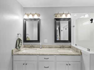 Full bathroom with double vanity and a sink