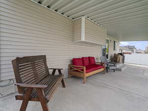 View of patio featuring outdoor lounge area and fence