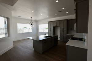 Kitchen featuring visible vents, a sink, baseboards, black dishwasher, and recessed lighting