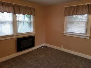 Carpeted spare room with baseboards