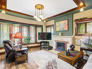 Living area featuring baseboards, plenty of natural light, and wood finished floors